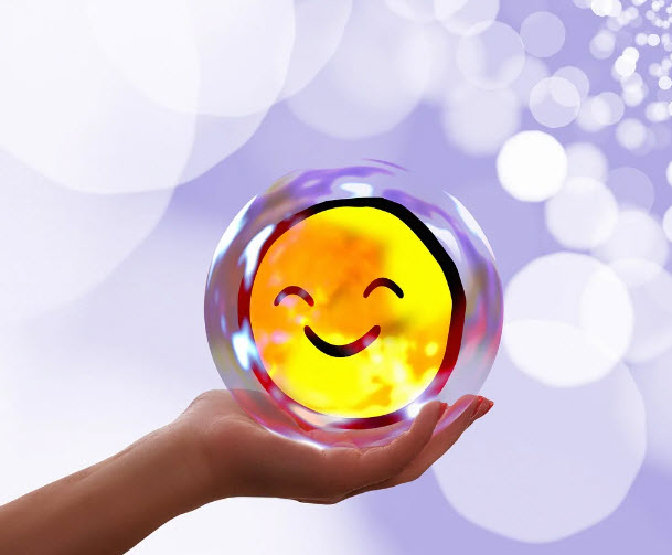 Hand holding happy face representing success of anger therapy 