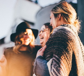 Three women smiling showing no signs of social anxiety