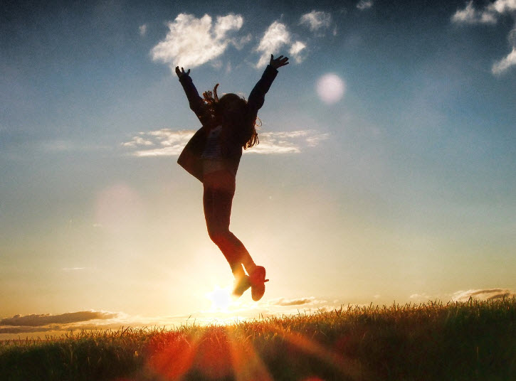 Woman jumping for joy after succesful mental health treatment