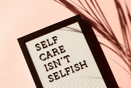 Mental health self care message spelled out on a sign